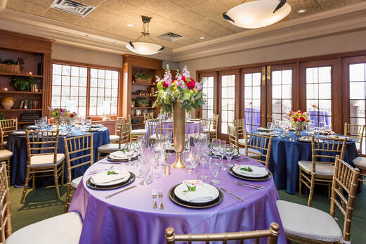 A well appointed banquet setting with a large flower centerpiece