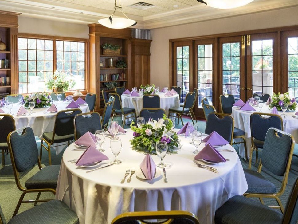 A very elegant banquet hall with large doors that lead outside to a patio
