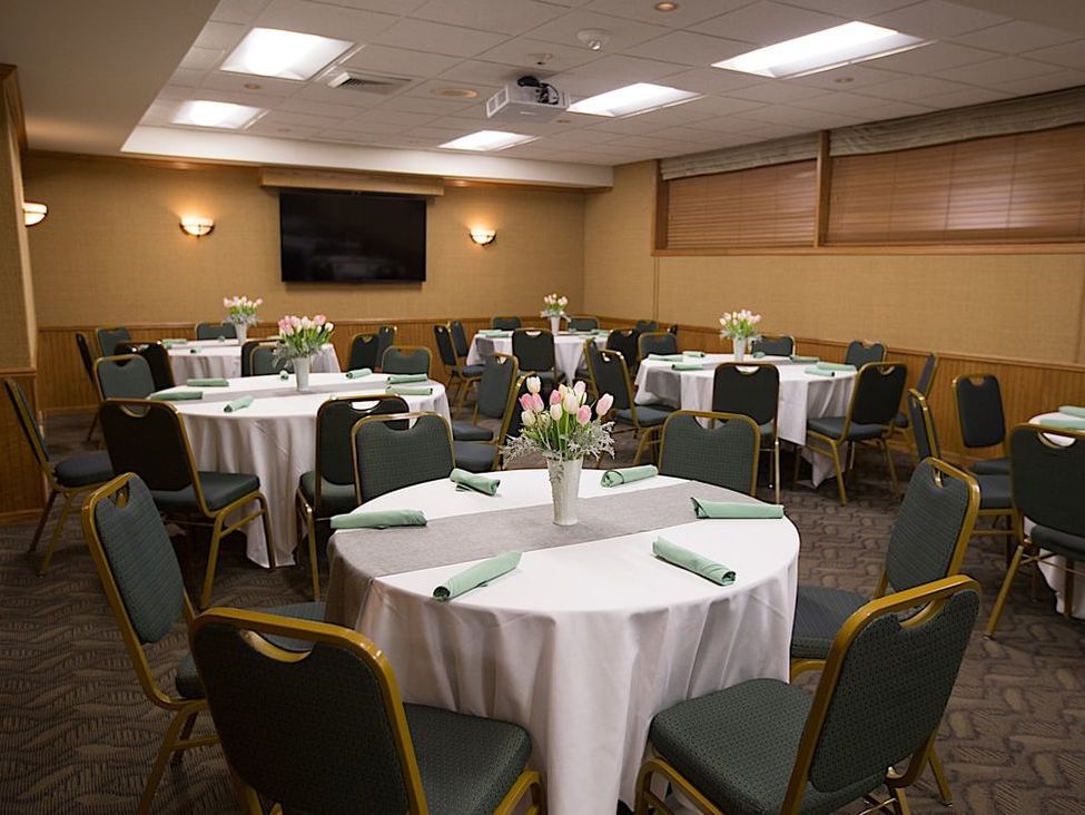 A simple banquet hall set-up with small flower centerpieces